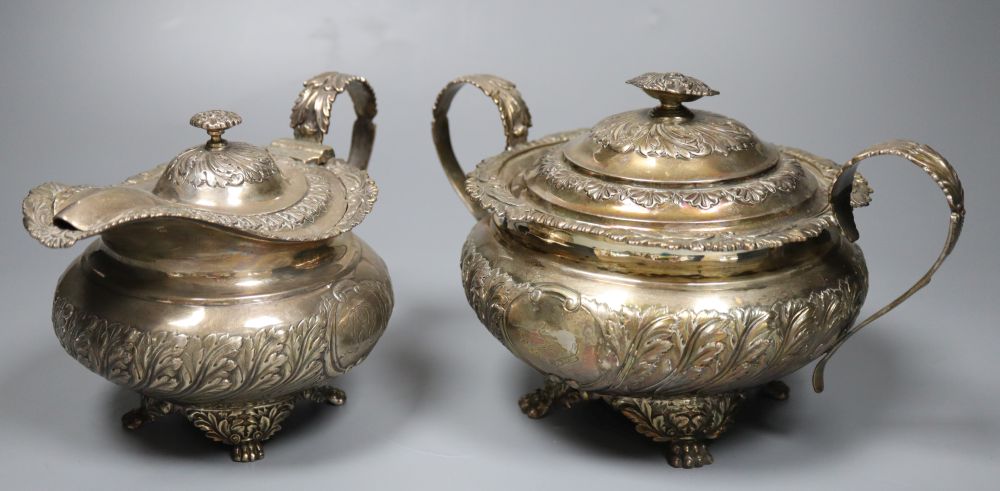 A George IV embossed silver lidded sugar bowl and matching cream jug, Joseph Angell I, London, 1823, 34.5oz.
